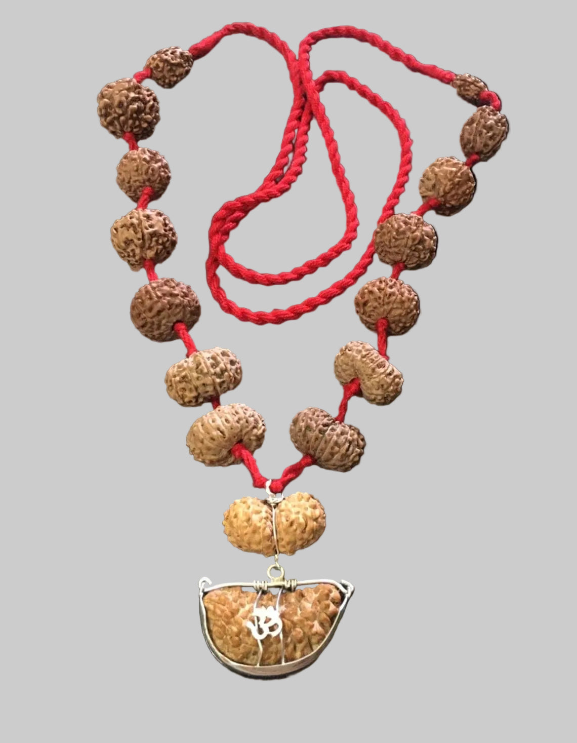 Necklace with brown beads and a silver pendant on a black background